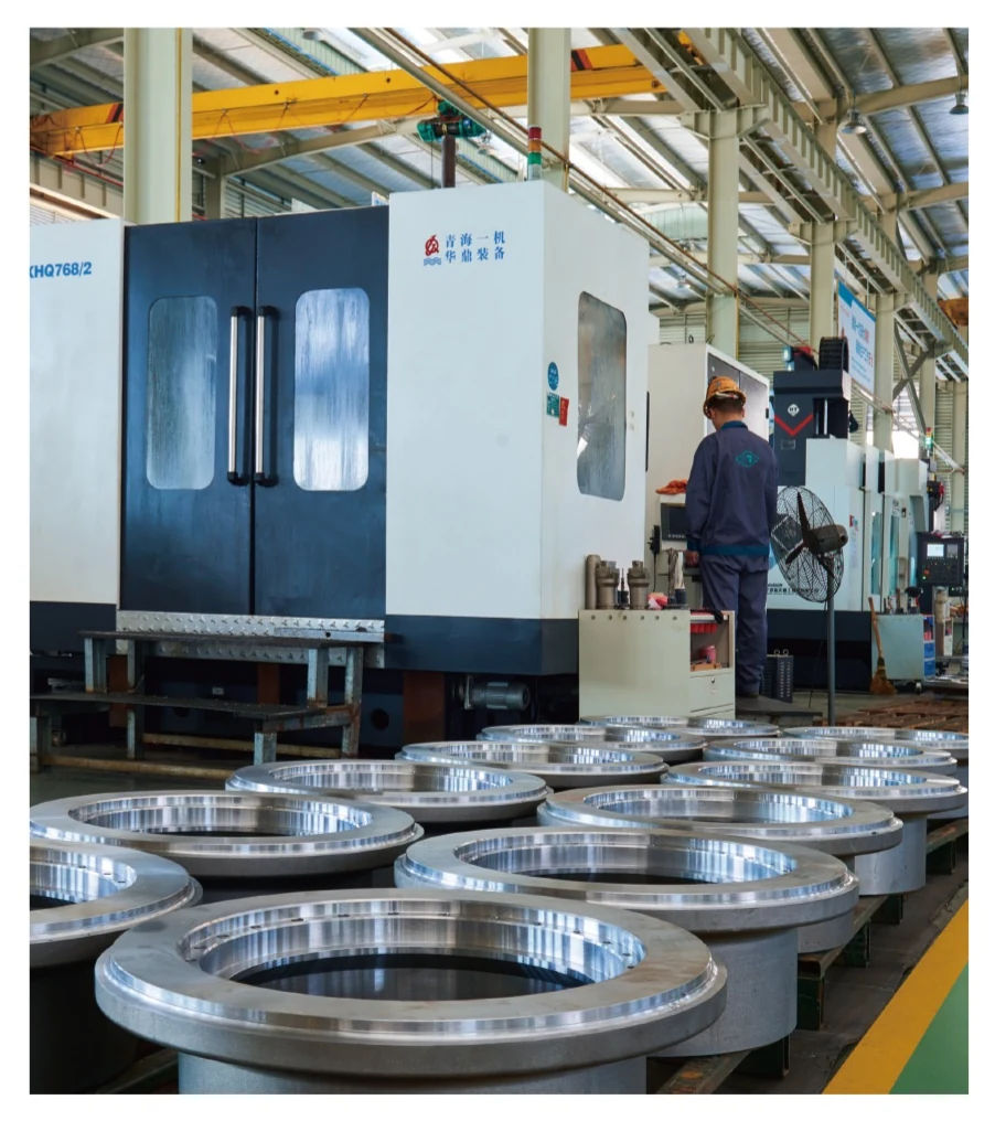 Machined valve components beside production equipment