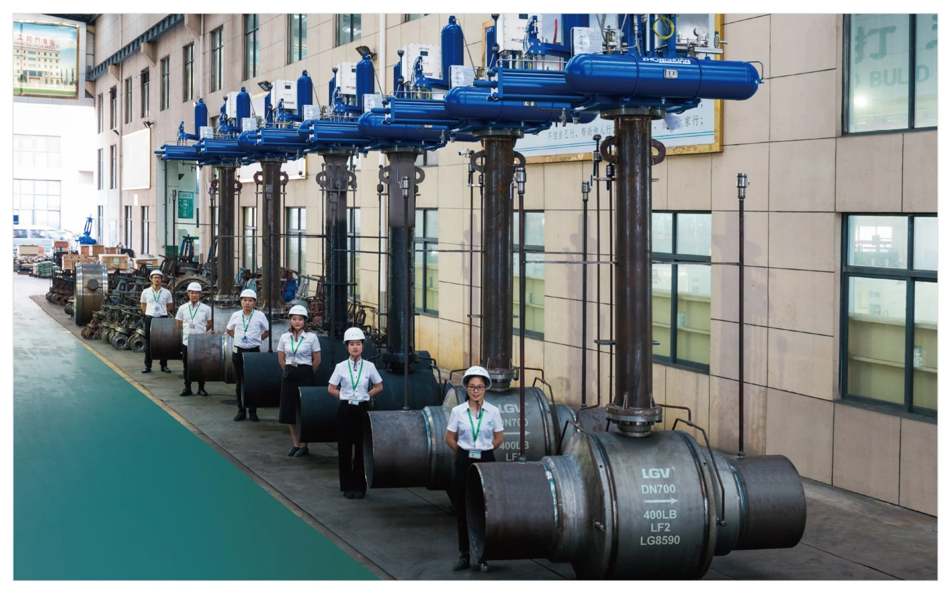Lianggong production team with large industrial valves in the workshop